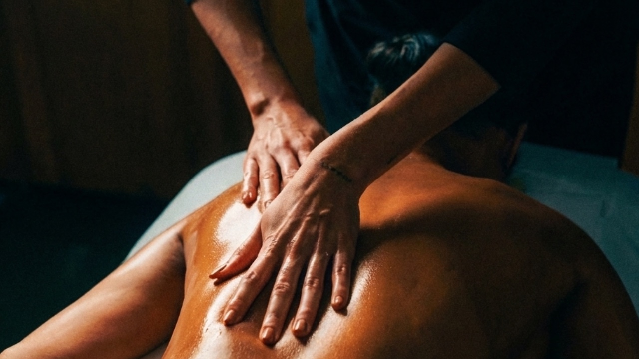 Ultra-realistic commercial photograph of a Loft Thai therapist performing a signature spa treatment in Bangkok