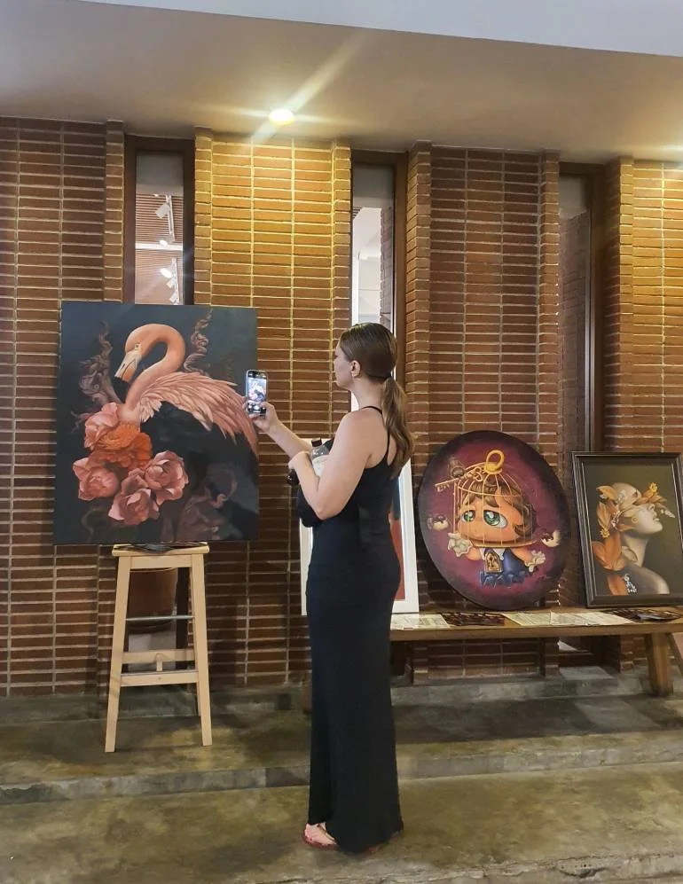 Visitor photographing paintings at ARTIS24 during Galleries’ Nights Bangkok 2025