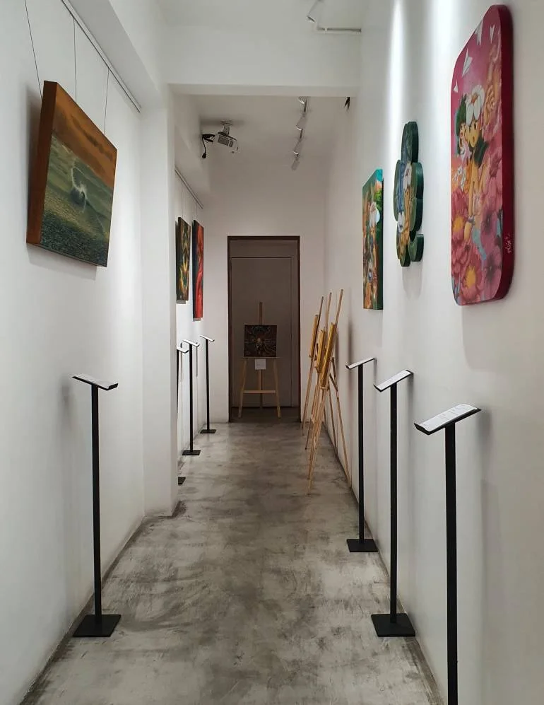 Real ARTIS24 exhibition corridor at Loft Thai Spa Sukhumvit 24 with contemporary artworks and gallery labels