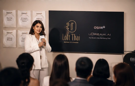 A speaker presenting the Loft Thai Spa and OSIM wellness collaboration to event guests