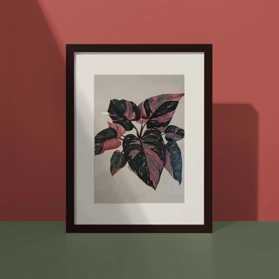 Framed botanical artwork with broad dark green and pink leaves from Tapanee Bautang’s archived Pink, Love, and Creatures presentation